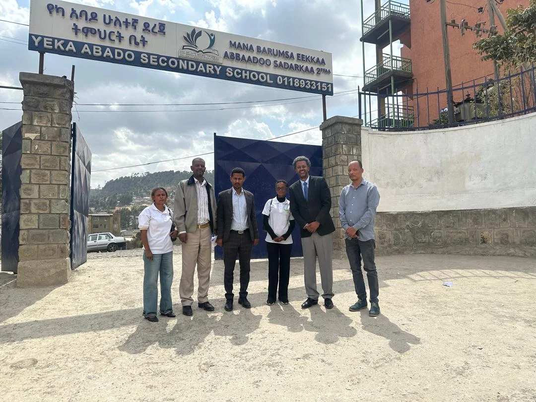 Eregeb and school representatives at Yeka Abado Secondary School